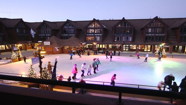 Magical view of ice skaters and the mountains from your private balcony 