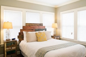 Back bedroom with handmade headboard and a rustic chic ambiance.