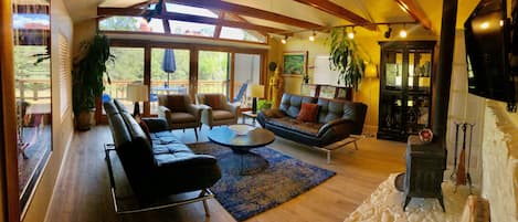 Our living room features a 16 foot wall of glass overlooking the Forest Service 