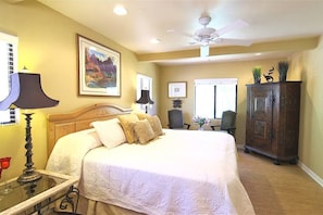 Master bedroom features a king sized bed, luxury linens and bamboo flooring