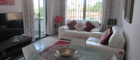 Modern And Comfortable Lounge. Sliding Doors Leading On To Furnished Balcony