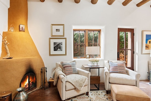 The sitting area next to authentic kiva fireplace