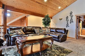 Comfortabe loft with leather reclining couches, chairs, and massage chair.