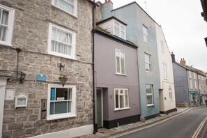 Teal House is the tall blue building.