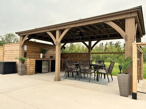 Gazebo w/ seating, fridge, sink. The other side has o/d shower to rinse in/out