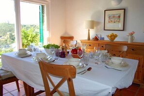 Dining space for 6 to 8 people with views of the valley down to the lake.