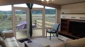 Front patio doors with covered patio table and too many chairs.
