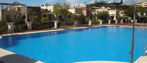 Main swimming pool directly behind apartment