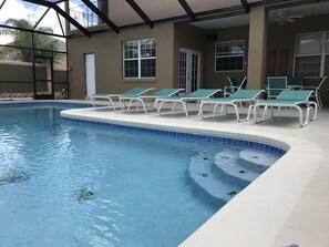Pool Loungers and chairs by poolside.