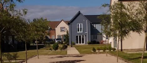 Rear of the cottage from the boules pitch, showing Beach Haven Cottage near RHS.