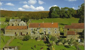 The beautiful setting of Postgate Farm. Postgate Nook is in the barn on the left