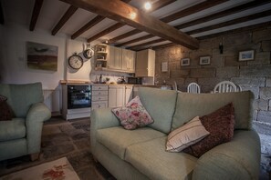 Cosy living room area with kitchen and dining area