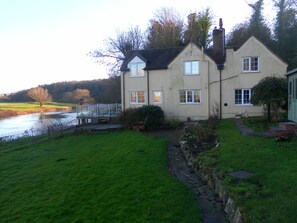 View of rear of property and garden showing proximity of river