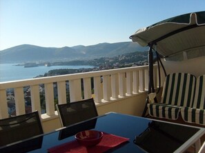 Balcony with swing seat, loungers and dining table and chairs 