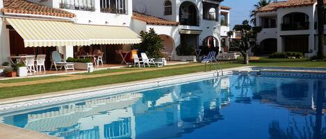 Left hand side, first floor apartment.(2 rectangle windows, overlooking the pool