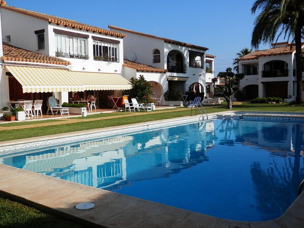 Left hand side, first floor apartment.(2 rectangle windows, overlooking the pool