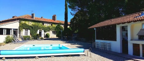 Pool and house with bar and pizza oven in foreground