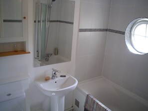 Bathroom with shower over the bath, downstairs