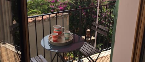 south facing balcony with folding table umbrella and small loungers