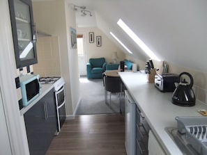 Open-plan living area showing the fitted kitchen.
