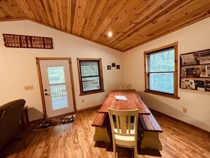 Dining area with custom reclaimed wood trestle table.