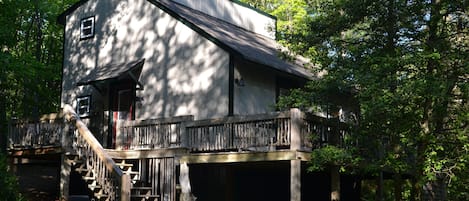 Rustic cabin, back in the woods, with a little creek.