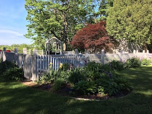 yard and gazebo next to pool area.