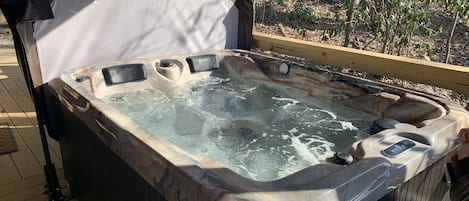 Perdonal hot tub on covered porch.  Great in all weather conditions.