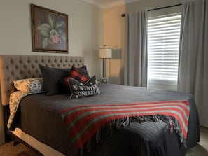 Cozy queen bed with velvet quilt will keep you warm.