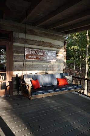 Over sized swing on the back porch is perfect for taking in the view or catnap