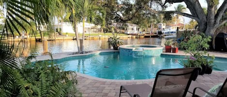 Beautiful free form pool with Jacuzzi over looking wide 120 ft canal