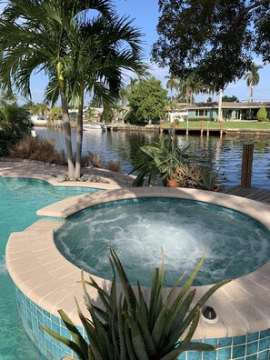 Relax in the  Jacuzzi while enjoying the canal