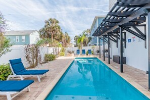 Large heated pool, accent lighting, ample seating, places to barbecue, dine, or sink into a hot tub.