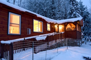 Welcoming cabin with ramp to porch and front door.