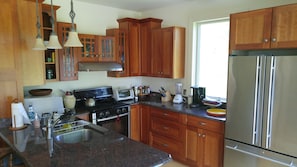Kitchen with granite counter tops and fully stocked pantry