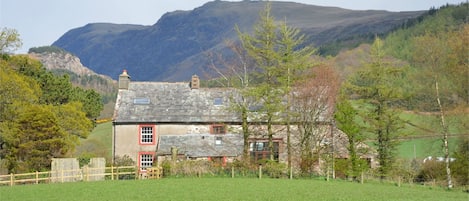 Hallflat Farm with Whin Rigg backdrop, farmhouse on left.
