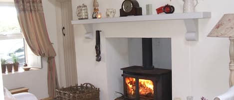 Sitting Room. Traditional Multifuel Stove, Turf Creel & Swiss Cow Bell. Cosy !!