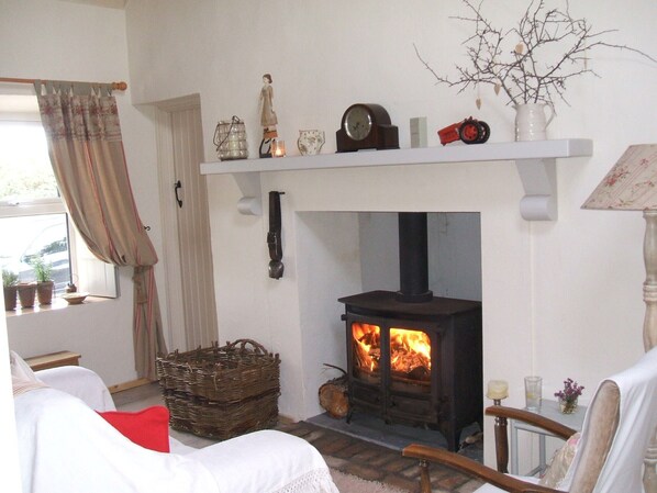 Sitting Room. Traditional Multifuel Stove, Turf Creel & Swiss Cow Bell. Cosy !!