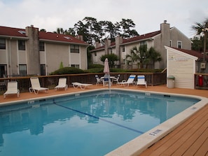 Gascoigne's neighborhood pool with tables, shower and chaise lounges.