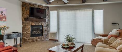 Large family room with comfortable seating featuring a fire place