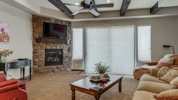 Large family room with comfortable seating featuring a fire place