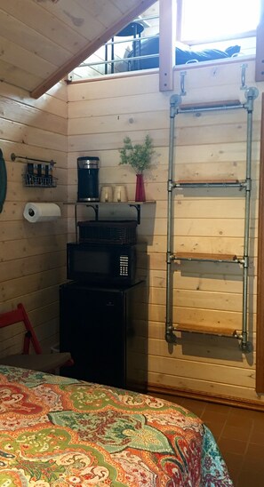 fridge, K-Cup coffee maker, microwave , Fold down table.