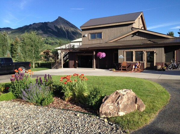 View of house with deck in Summer.