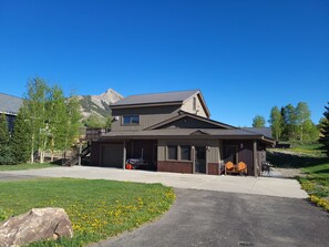 View of house with deck in Summer.