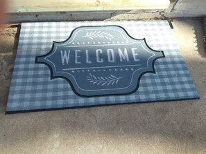 Guests are greeted with a welcoming country mat at the main door. 