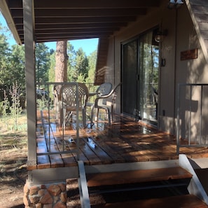 Spacious front porch with a great view of ponderosa trees.