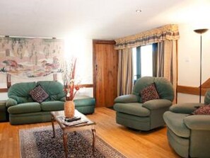 Lounge with two comfortable reclining arm chairs a sofa and a sofa bed. 