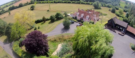 Paddock Barn in ground floor of black barn, surrounded by countryside.