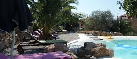 Natural lake-shaped pool in the middle of a Mediterranean garden 