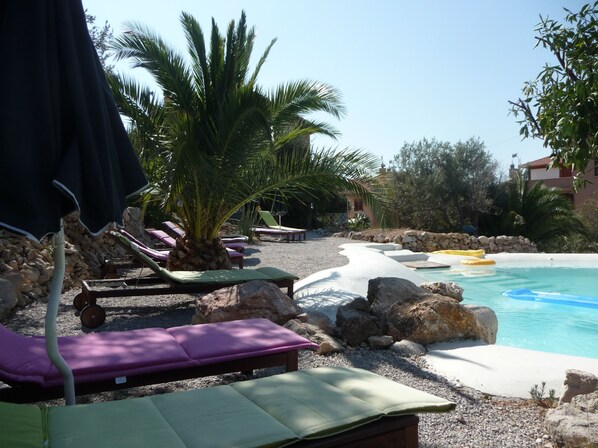 Natural lake-shaped pool in the middle of a Mediterranean garden 